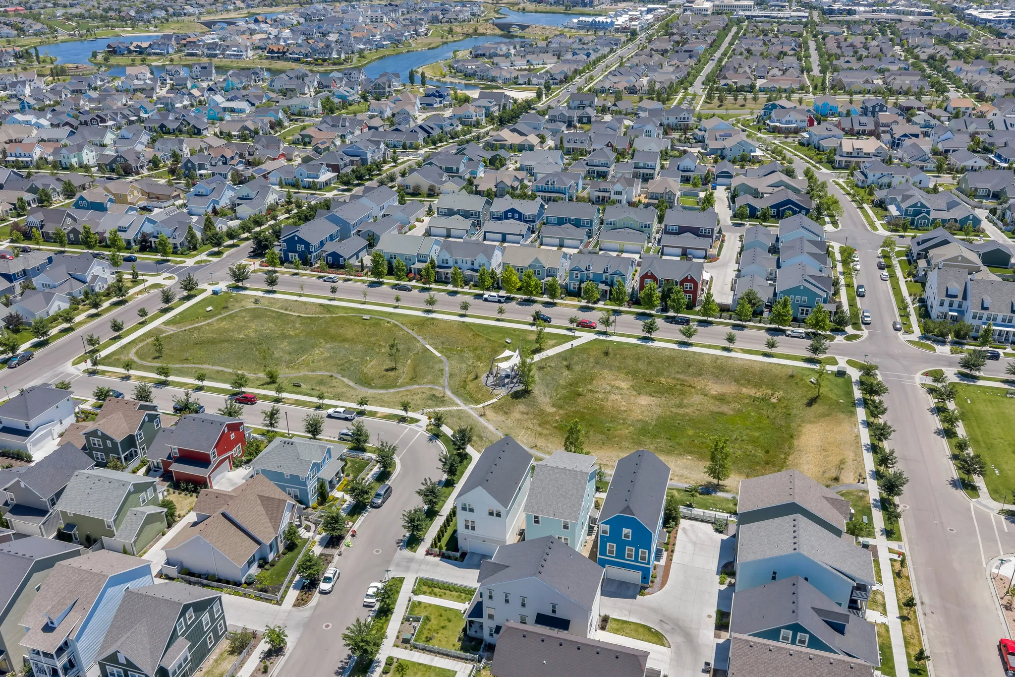 Expansive aerial view of a residential community featuring a central green space