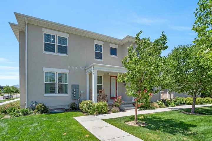 Stucco exterior with a covered porch and white columns