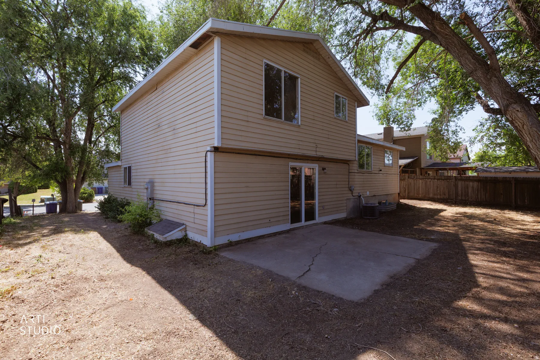 Rear exterior with beige siding and multiple windows