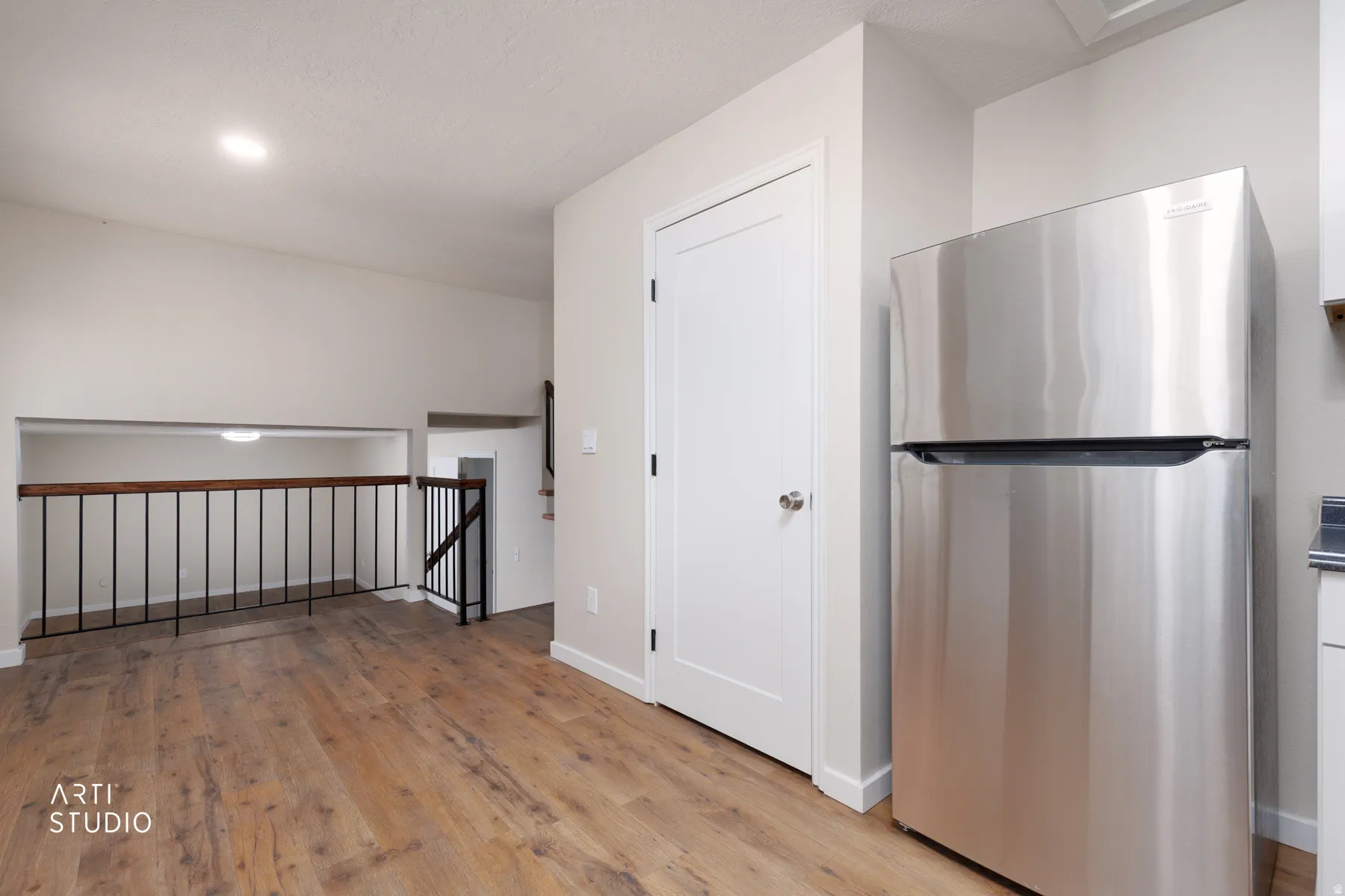 Stainless steel refrigerator with wood-finish flooring