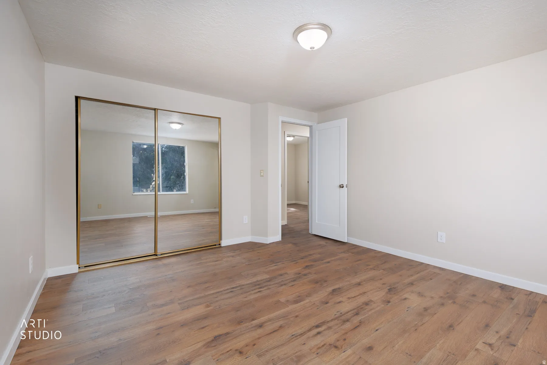 Master BedRoom featuring wood-finish flooring, light-toned walls, and a ceiling-mounted light fixture