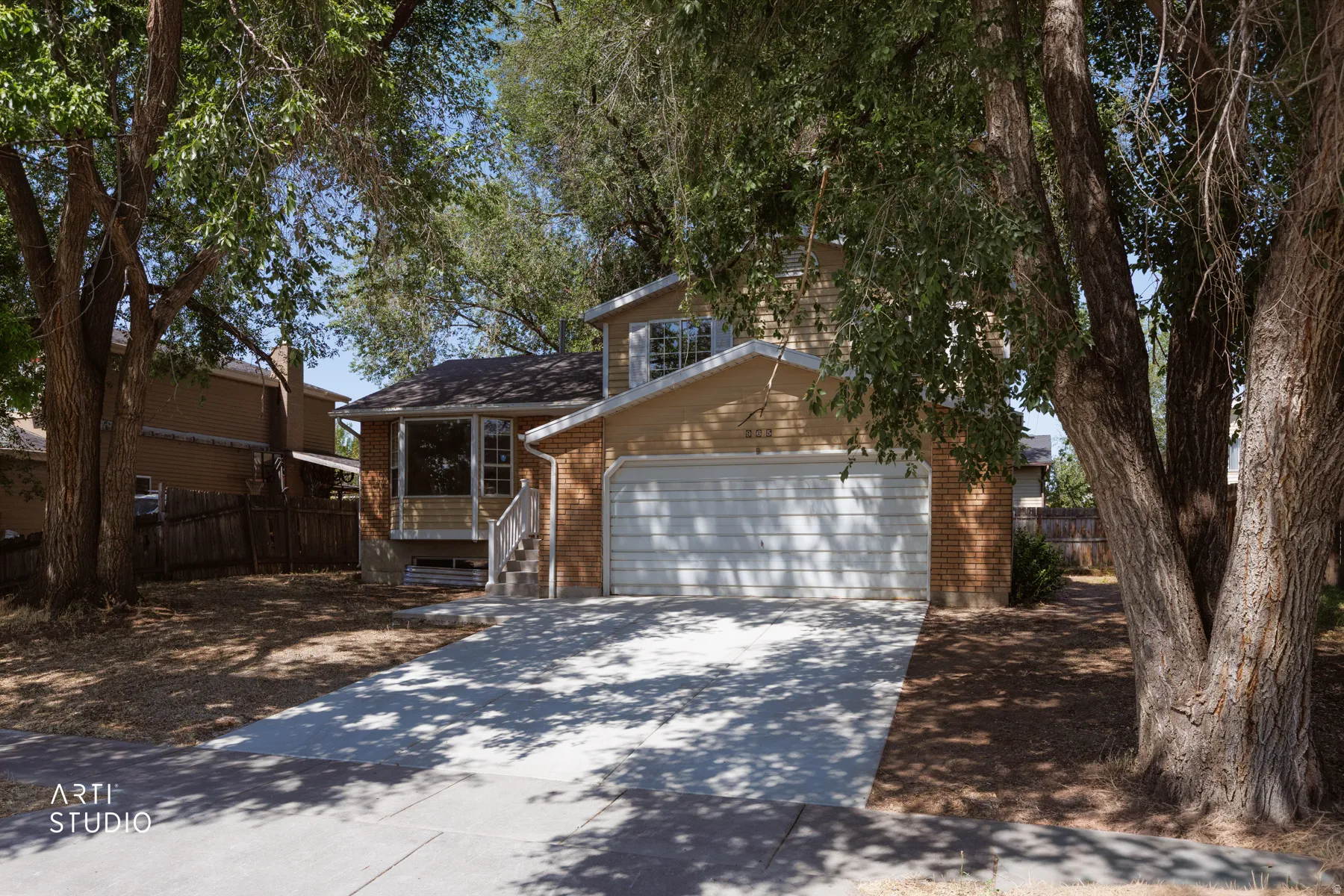 Traditional exterior featuring brick and horizontal siding accents