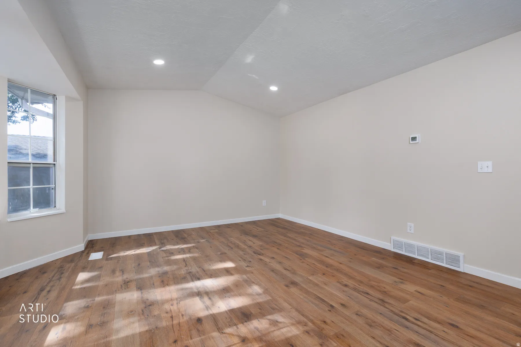 Room featuring wood-finish flooring, recessed lighting, and a neutral wall color