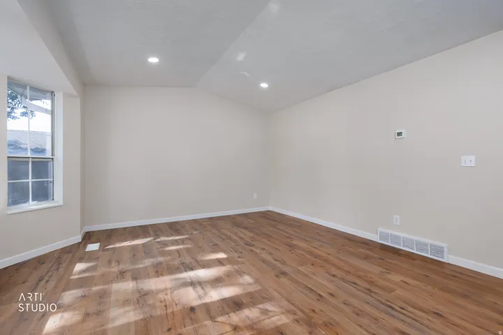 Room featuring wood-finish flooring, recessed lighting, and a neutral wall color