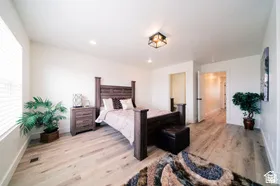 Spacious room featuring light wood-finish flooring, recessed lighting, and a modern ceiling fixture