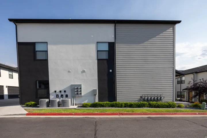 Contemporary exterior featuring a flat roofline, horizontal siding, and stucco finishes
