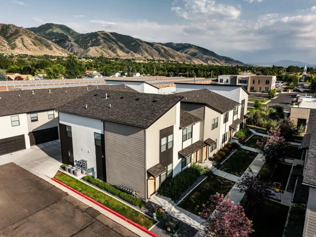 Contemporary townhome exteriors featuring multi-toned siding and dark shingle roofing
