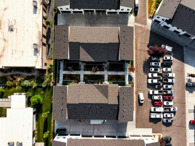 Overhead perspective of residential structures featuring dark shingle roofing