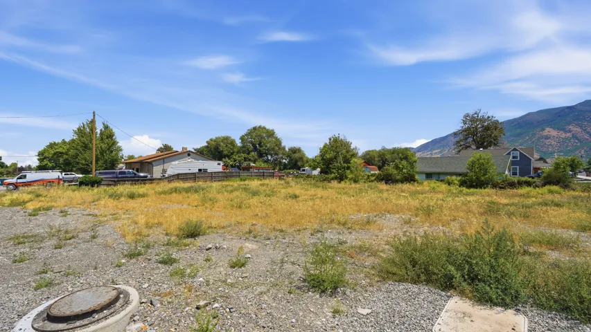 Expansive vacant land featuring a clear, level surface and distant mountain scenery