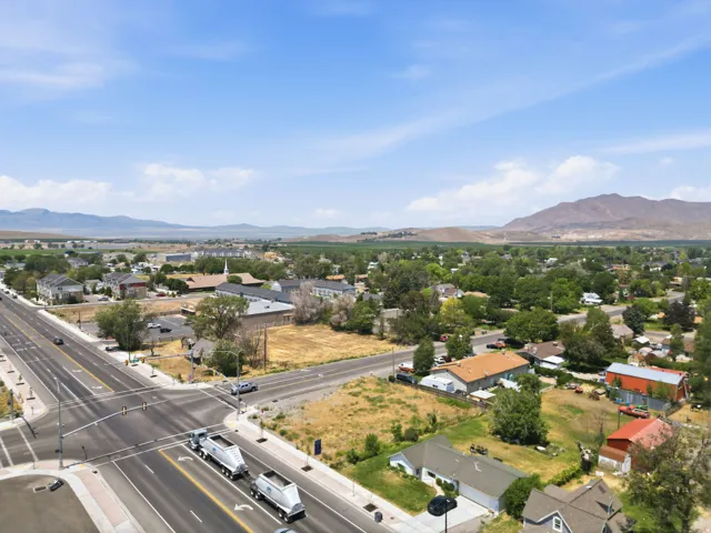 Aerial perspective showcasing a community with diverse architectural styles, mature trees, and a prominent intersection