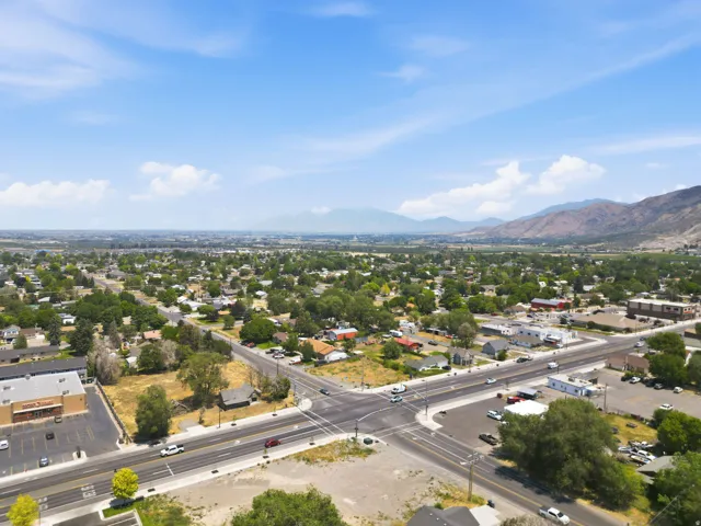 Expansive aerial perspective showcasing a developed community with established residential areas and commercial buildings