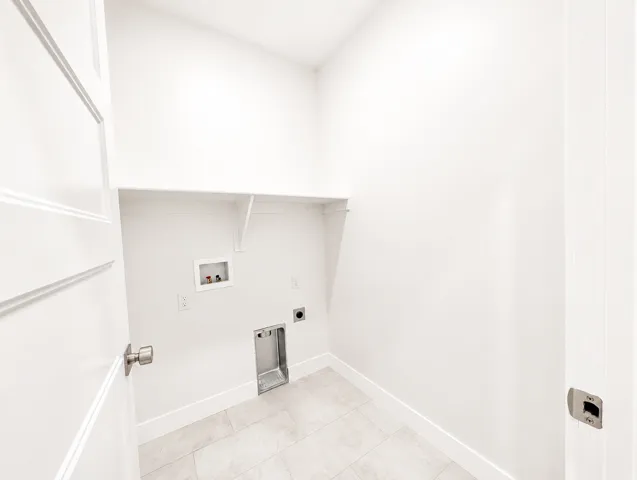 Laundry area featuring tile flooring, white walls, built-in shelving, and hookups for appliances