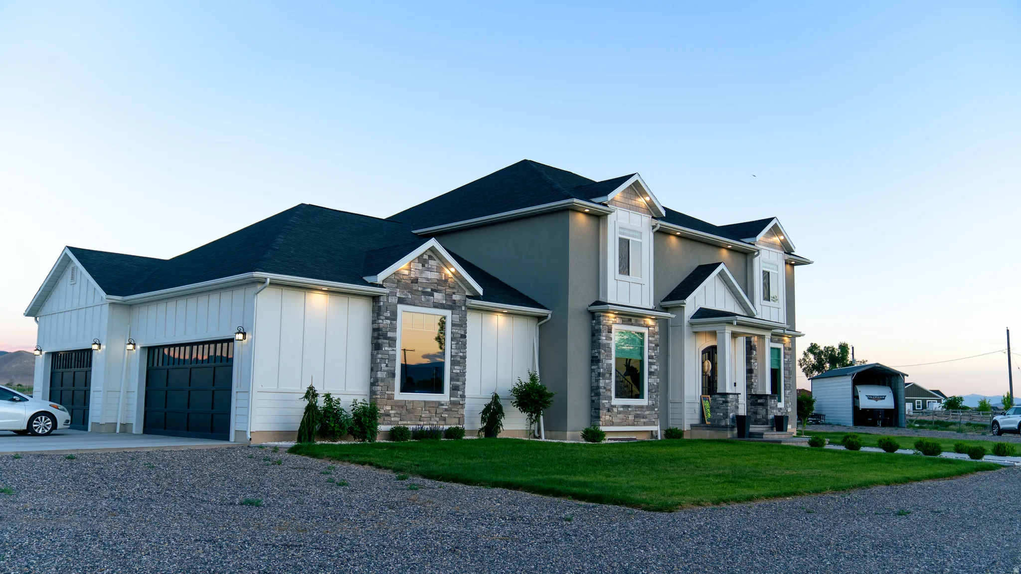 Contemporary residence featuring a multi-textured facade with stucco, board and batten siding, and stone accents