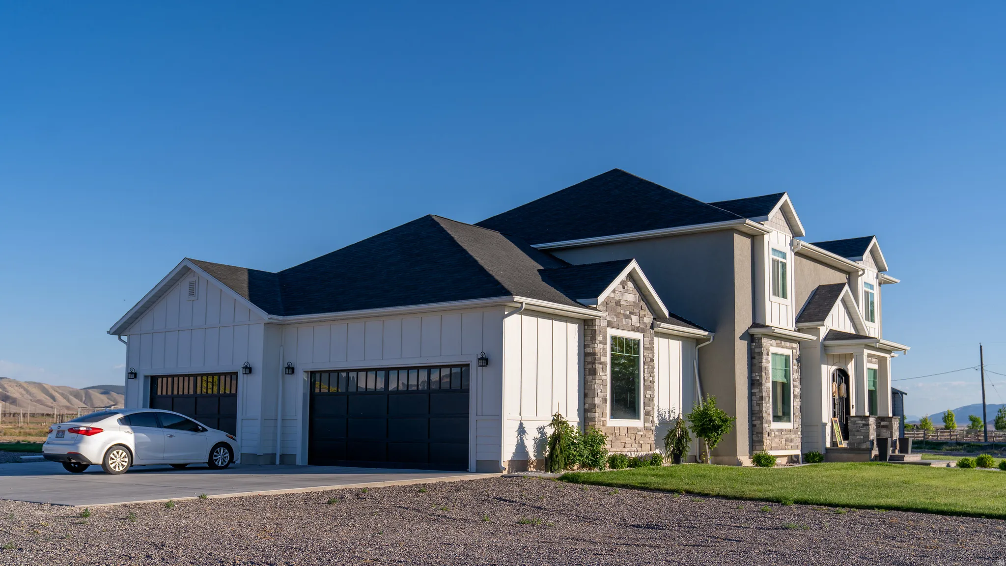 Contemporary exterior featuring a combination of board and batten siding, stucco, and stone accents