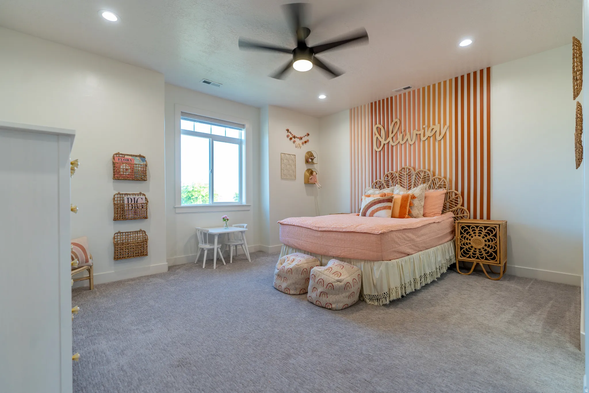 Bedroom featuring a textured accent wall, recessed lighting, ceiling fan, carpet flooring, and a double-pane window