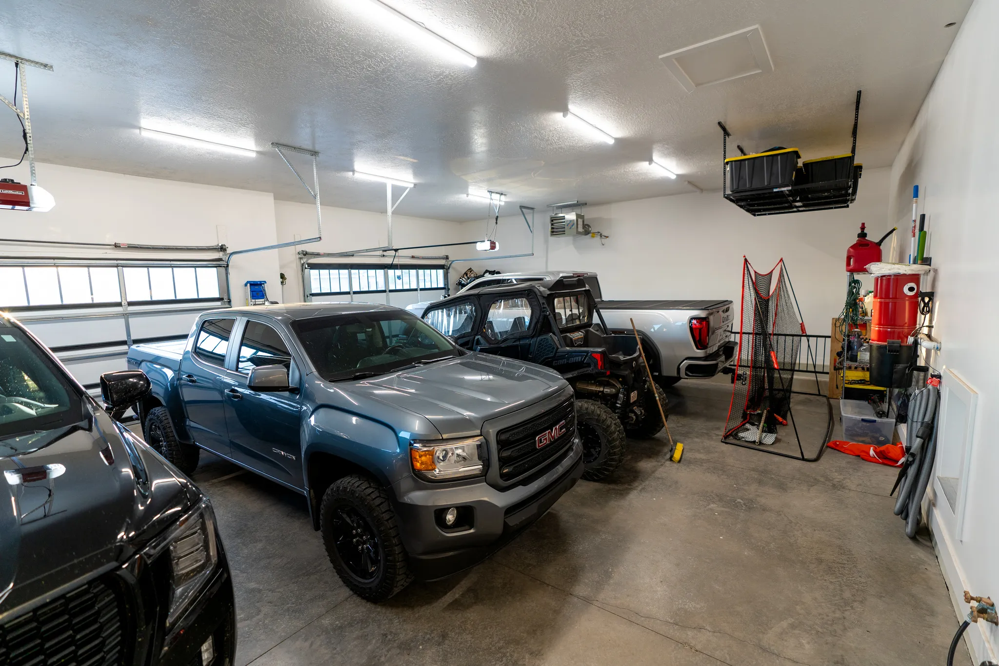 Spacious garage featuring concrete flooring and white walls
