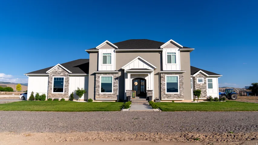 Contemporary residence featuring a stucco and stone facade with white trim