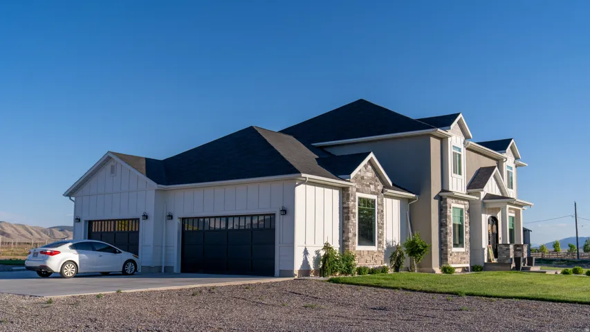 Contemporary exterior featuring a combination of board and batten siding, stucco, and stone accents