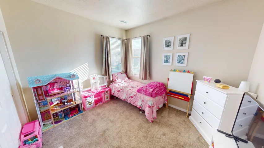 Carpeted room featuring light neutral wall paint and white trim