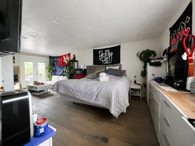 Spacious room featuring wood-finish flooring, recessed lighting, and a white ceiling