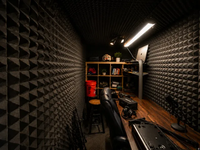 Dedicated sound-insulated room featuring acoustic foam paneling on walls and ceiling