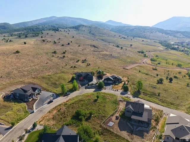 Aerial perspective showcasing multiple properties nestled into a mountainous landscape