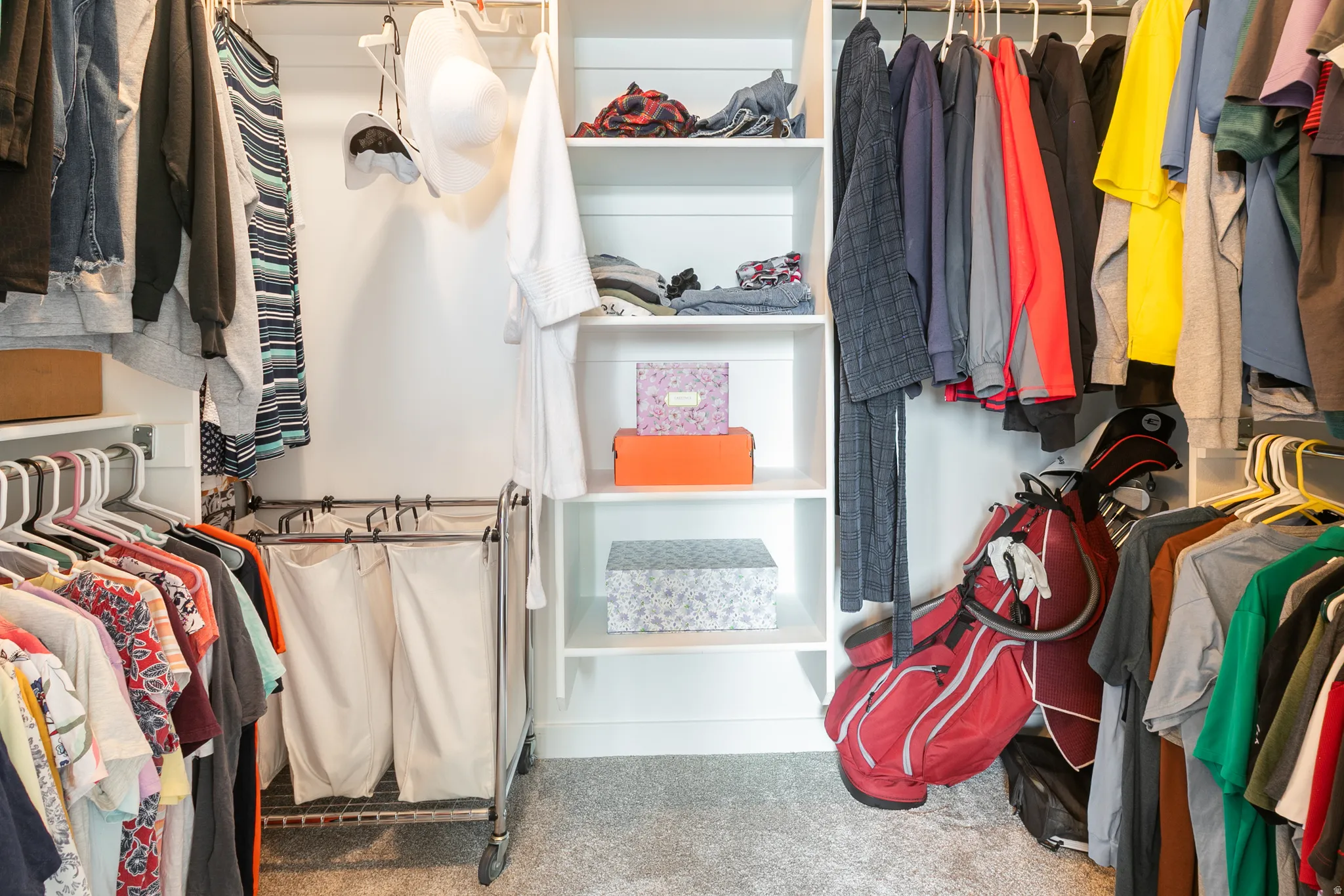Custom closet system featuring white shelving and hanging rods