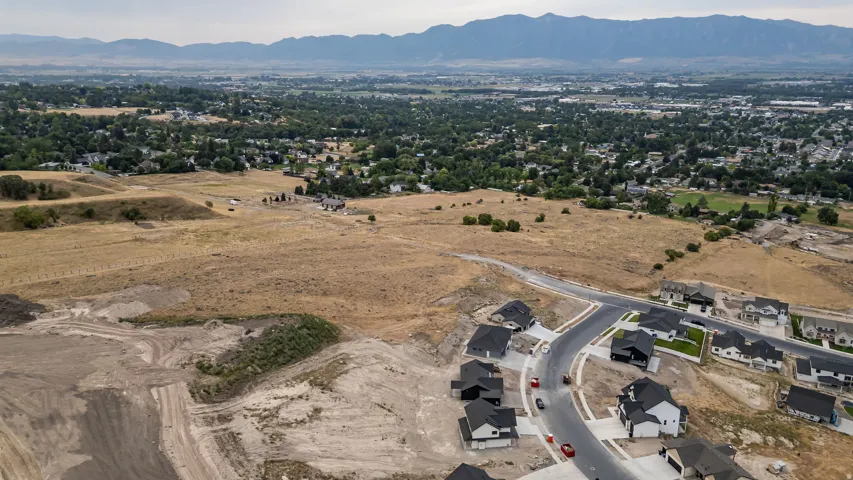 Mountainous backdrop, established residential areas, and undeveloped land parcels