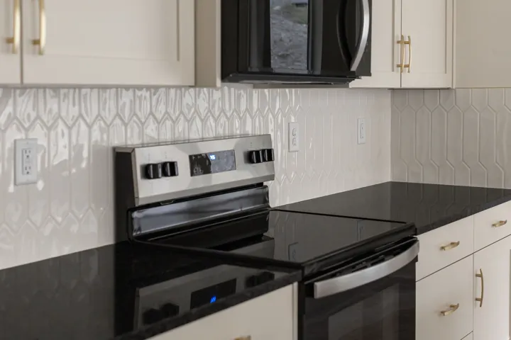 Sleek black cooktop range with a stainless steel oven