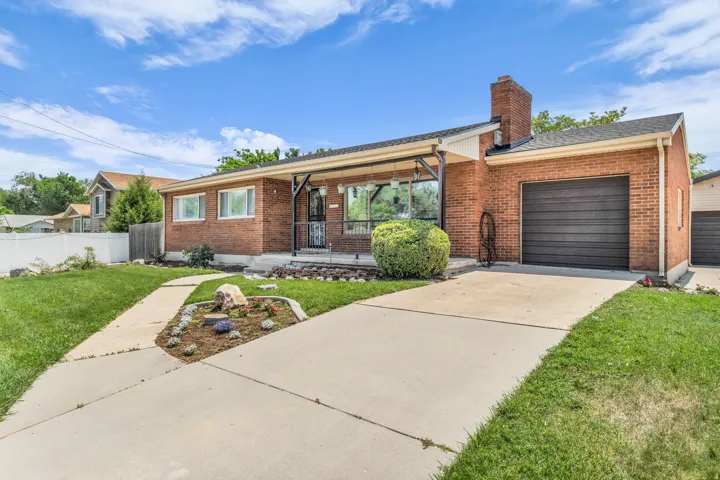 Brick exterior with a covered front porch and a paved driveway