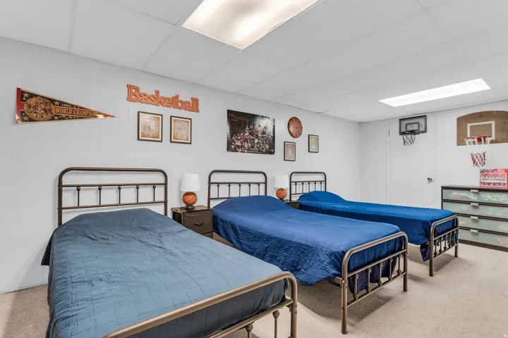 Carpeted room with drop ceiling, recessed lighting, and white paneled walls