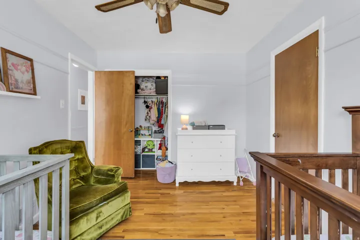 Hardwood flooring extends throughout the room, complemented by light gray walls