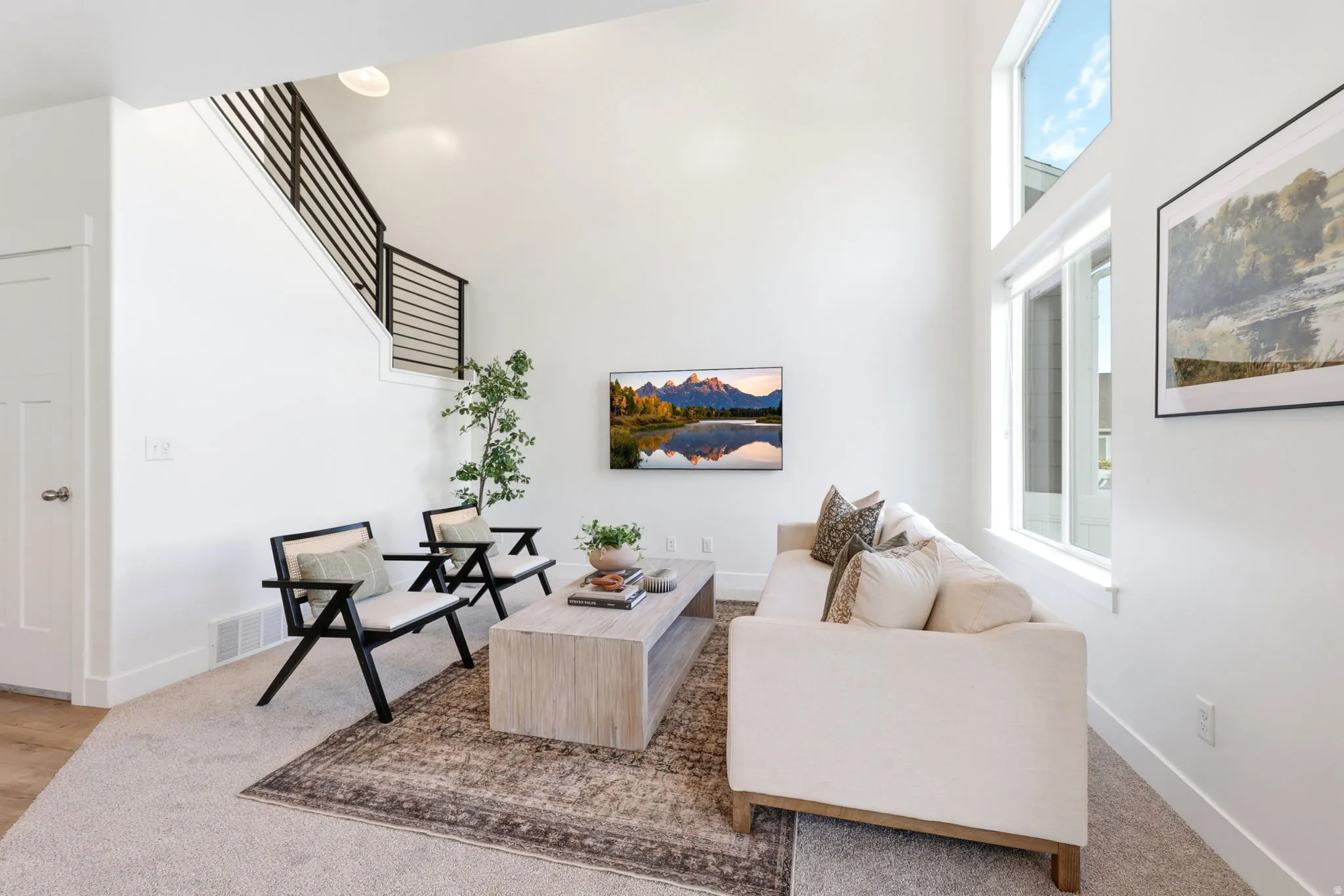 Spacious living area featuring double-height ceilings and tall windows