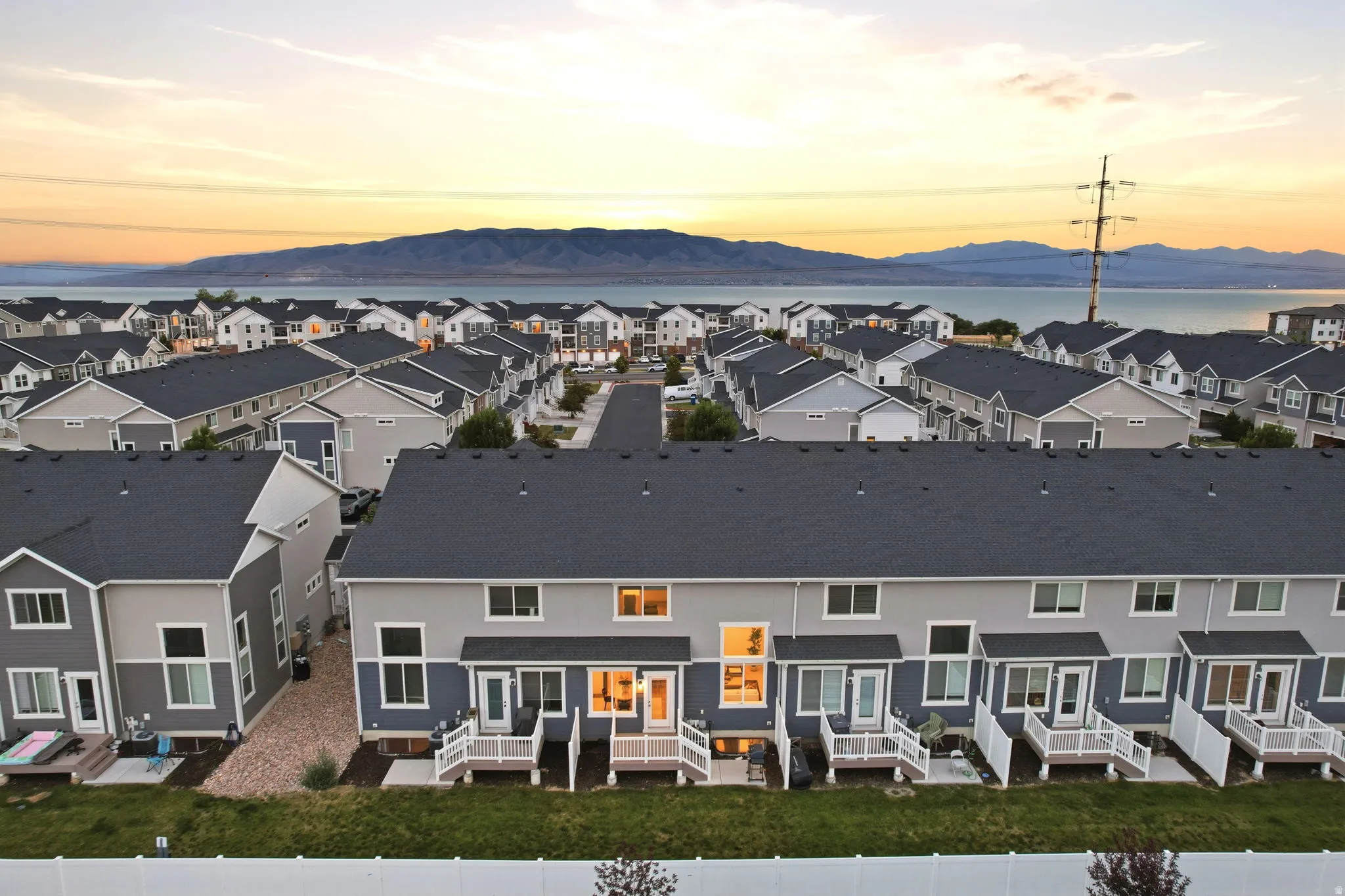 Rear facades of multi-unit residences featuring balconies with white railings