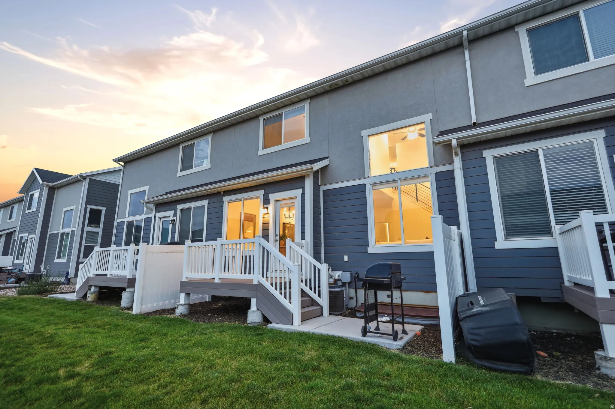 Townhome exterior featuring blue siding and a light gray stucco finish
