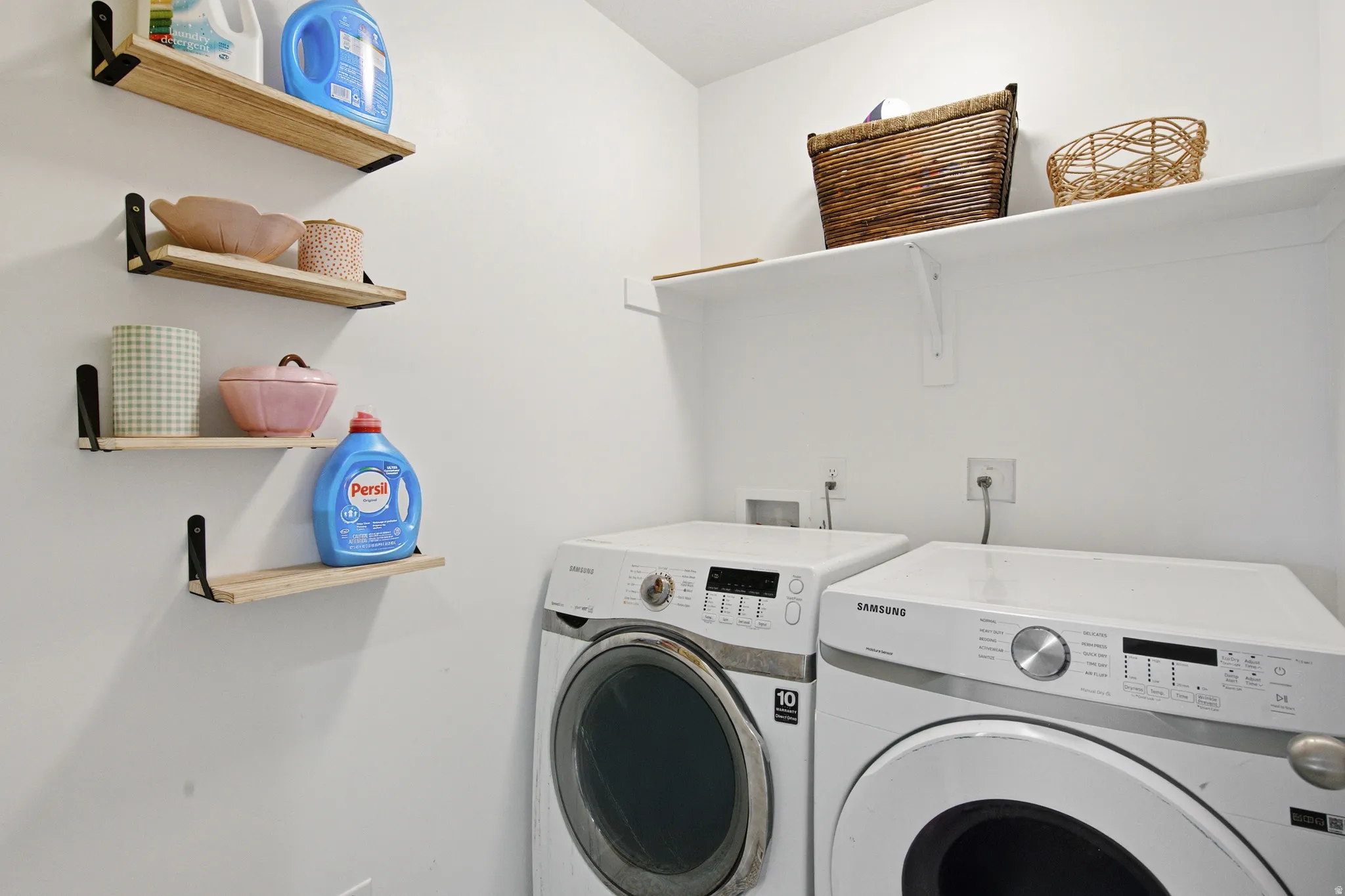 Dedicated laundry area featuring a white wall finish