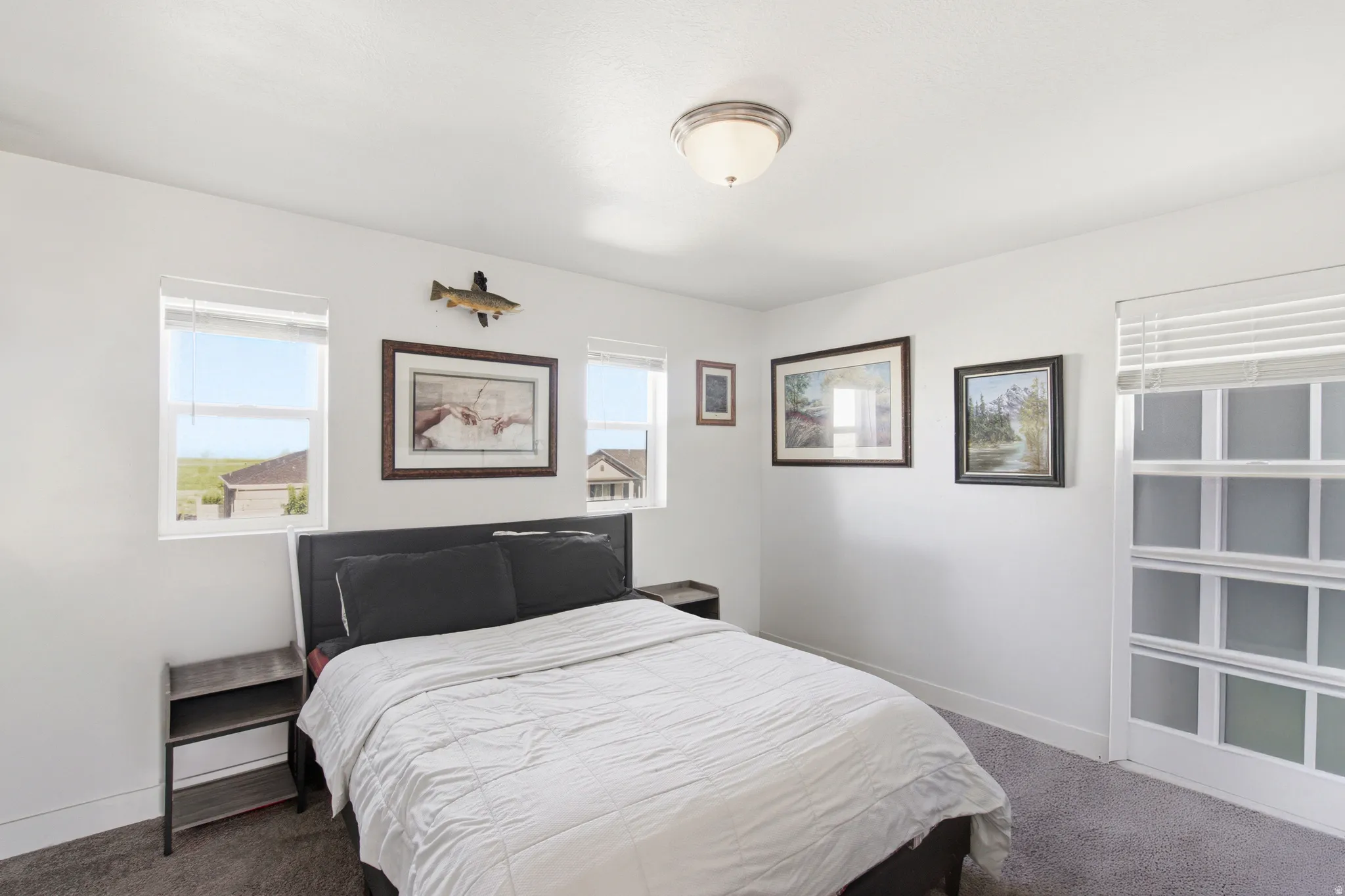 Carpeted interior room featuring white walls and a semi-flush mount ceiling light fixture