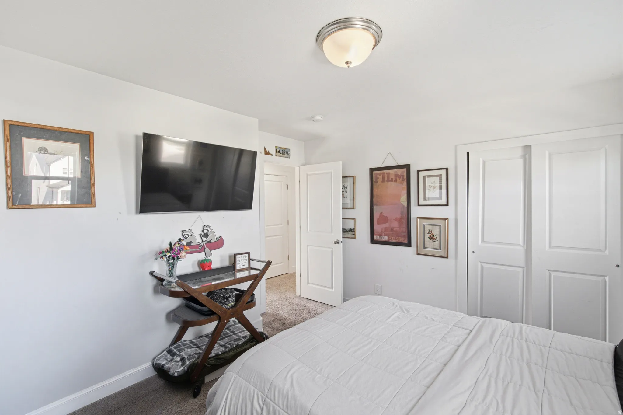 Interior room featuring light-colored walls and gray carpet flooring