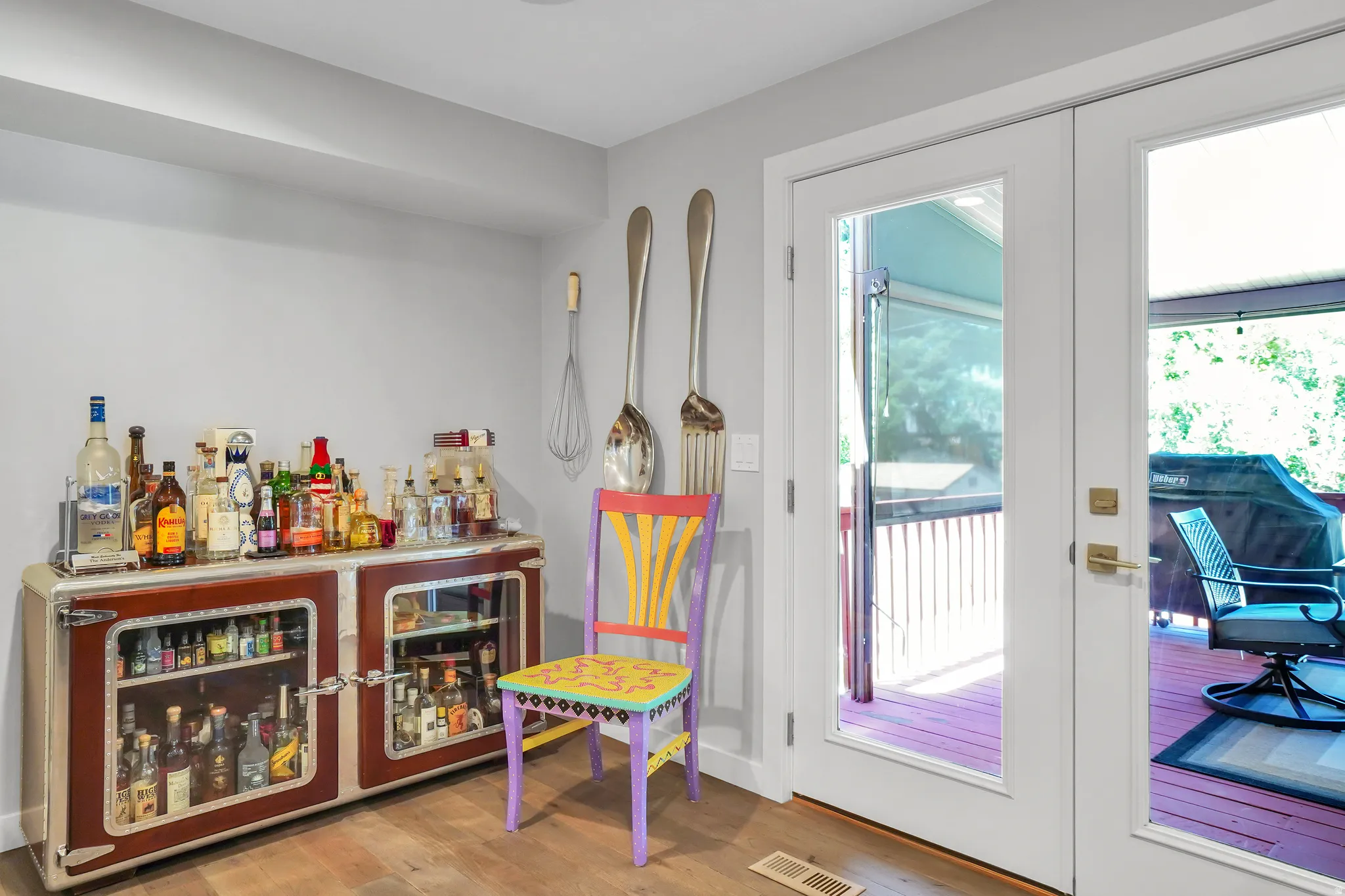 French doors opening to an outdoor deck, wood-finish flooring, recessed lighting, and light gray wall paint