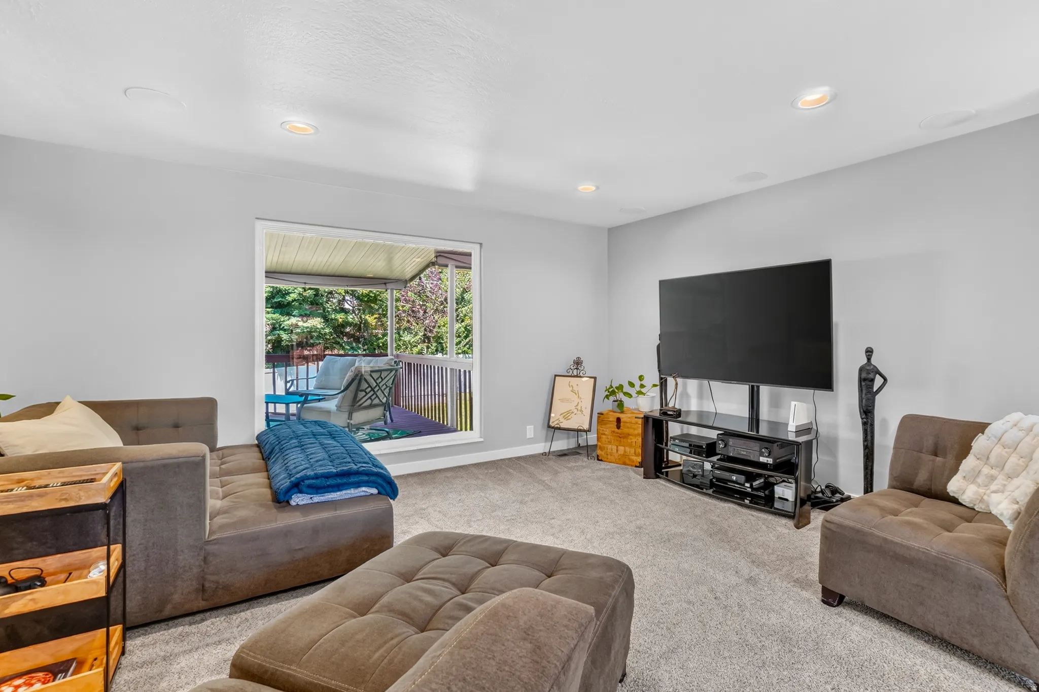 Spacious room featuring light gray walls, recessed lighting, and soft carpet flooring