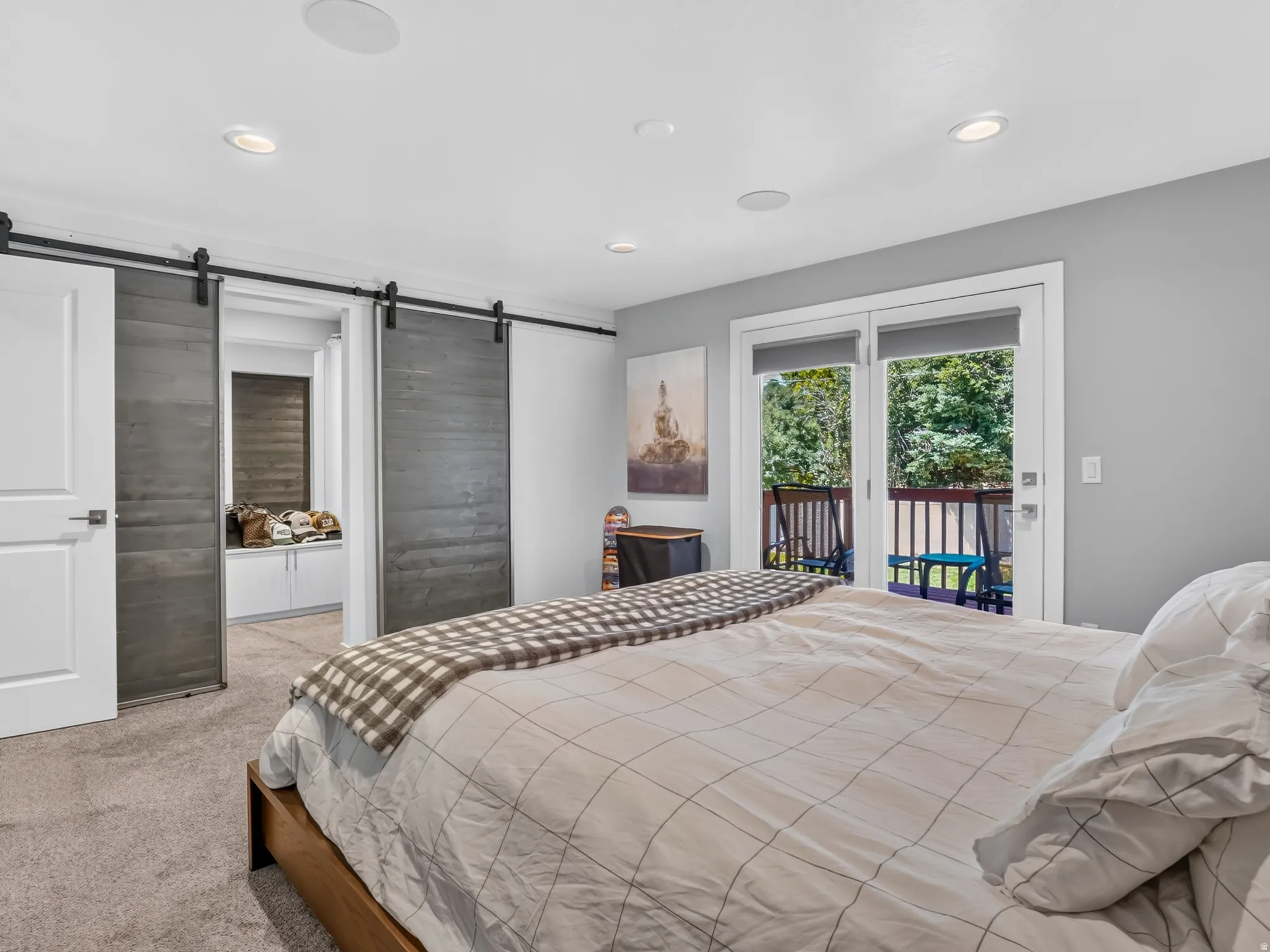 Bedroom featuring sliding patio doors, recessed lighting, and dual barn doors