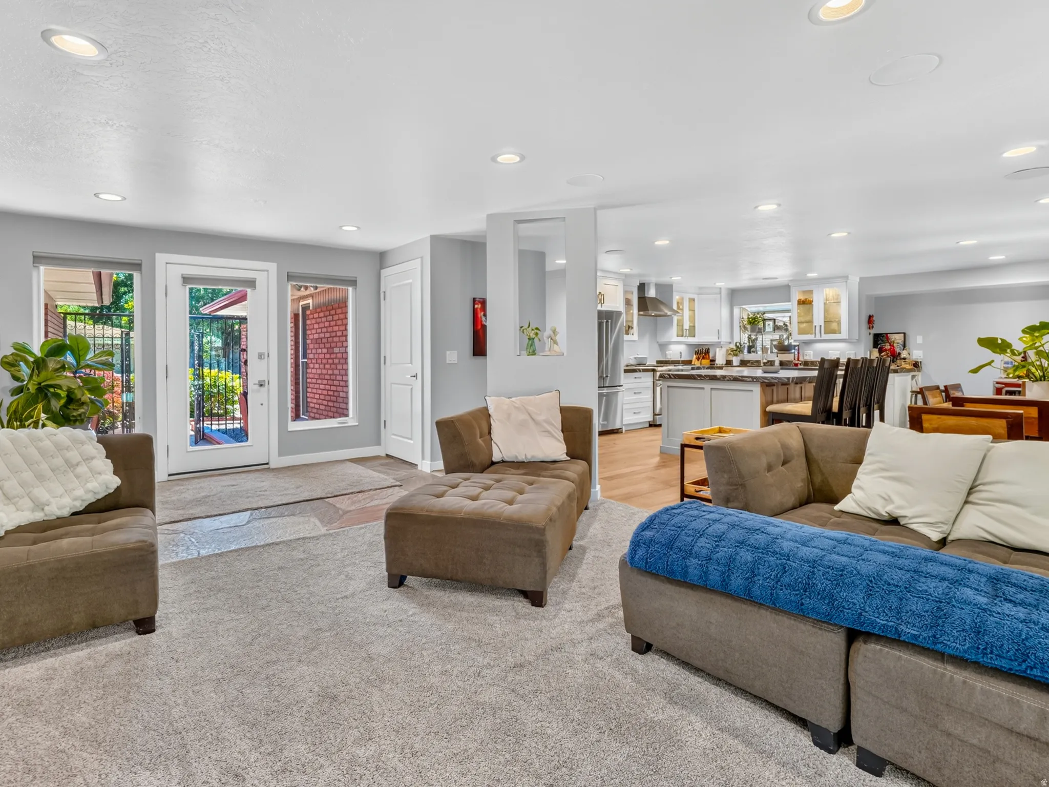 Spacious living area featuring light gray walls and recessed lighting