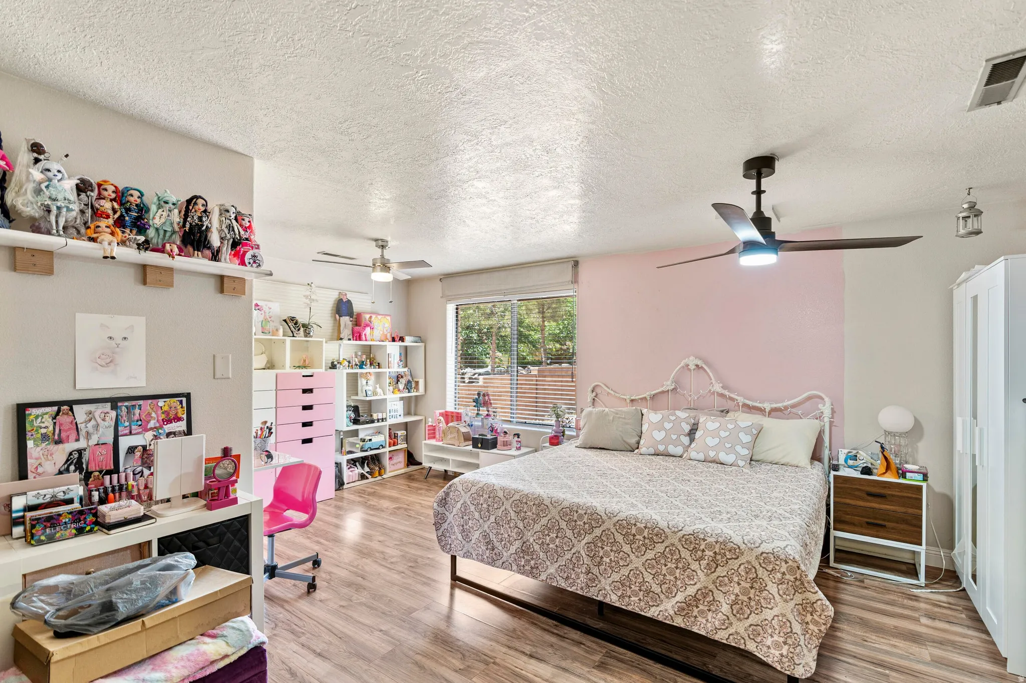 Bedroom featuring wood-finish flooring, a contemporary ceiling fan, and a window with horizontal blinds