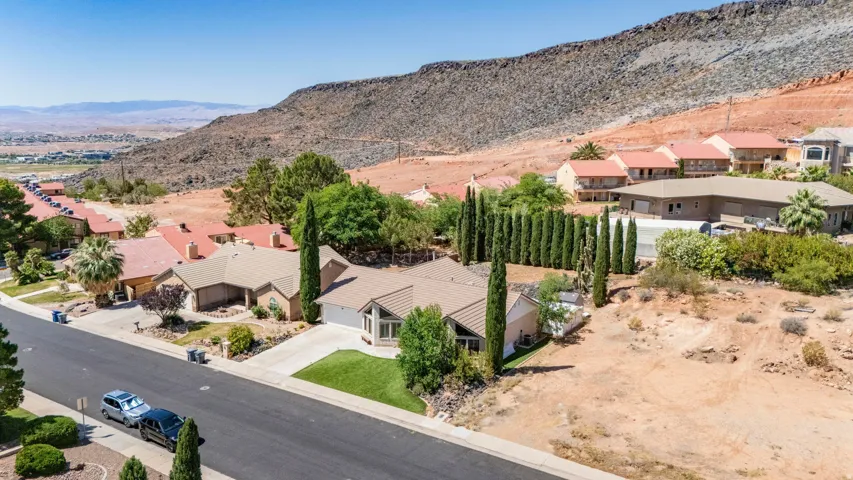 Single-story property with a light-colored stucco exterior and a tan shingle roof