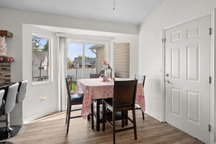 Dining area featuring wood-finish flooring and a bay window