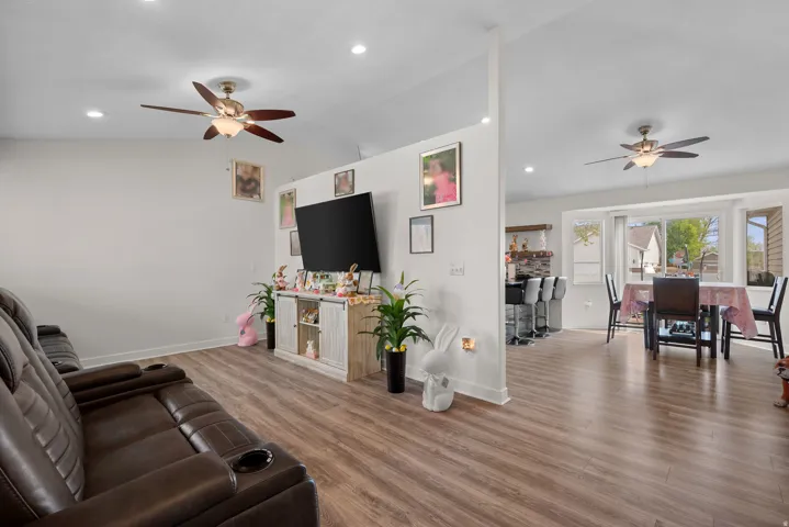 Open-concept living space featuring wood-finish flooring throughout
