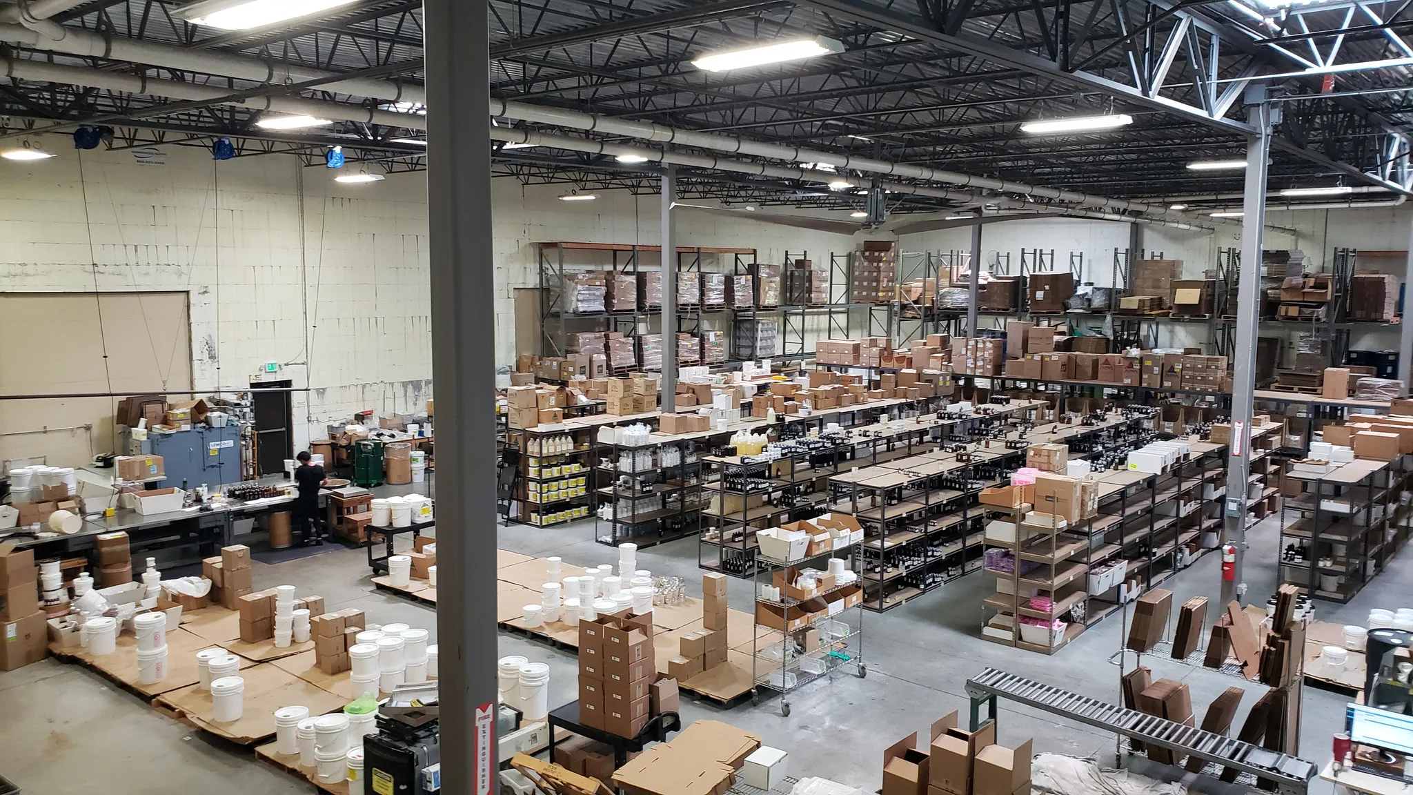 Expansive industrial warehouse space with high ceilings and exposed structural elements