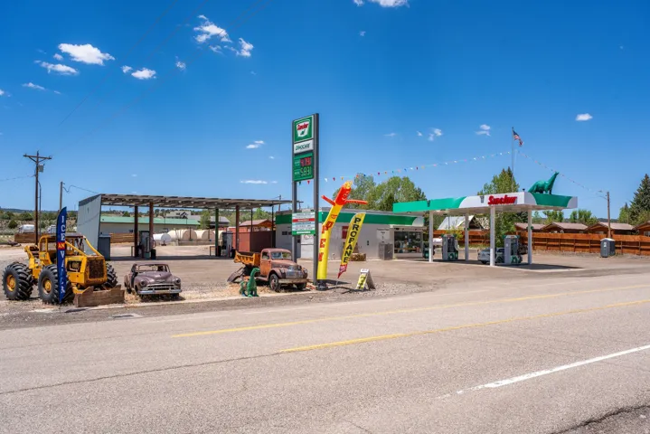 Roadside retail property featuring multiple covered fuel pumps and a single-story commercial building