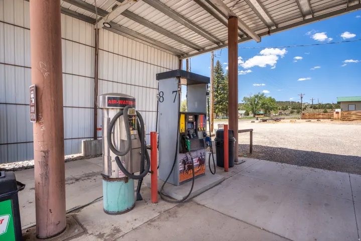 Covered fueling station featuring multiple pumps and an air/water dispenser