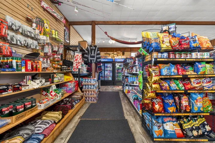 Retail interior featuring wood-paneled walls and exposed wood ceiling beams